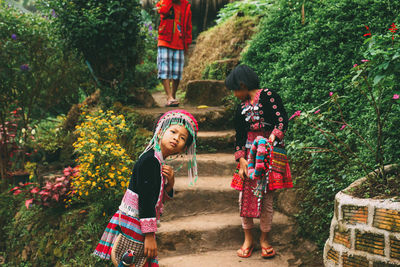 Full length of mother with daughter against trees