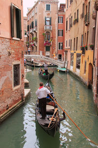 Boats in canal with buildings in background