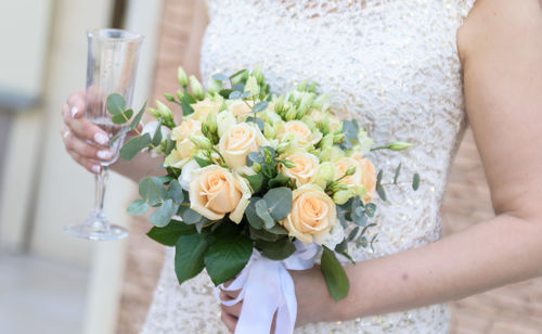 Midsection of woman holding flower bouquet