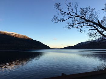 Scenic view of lake against sky at sunset