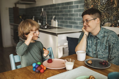 Mother with child sitting at table