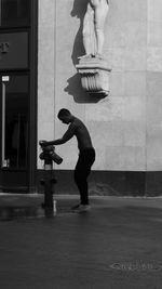 Low section of woman walking on street