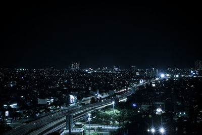High angle view of illuminated buildings in city at night