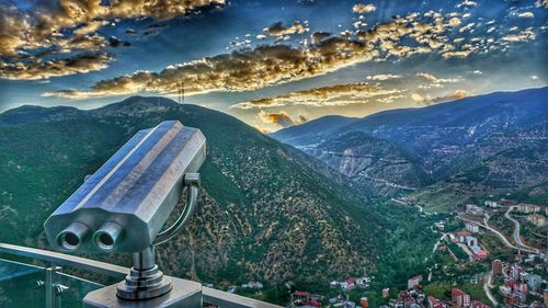 Aerial view of city and mountains against sky