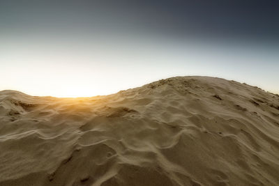 Scenic view of desert against clear sky