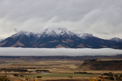 Scenic view of mountains against cloudy sky