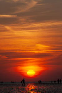 Scenic view of sea against orange sky