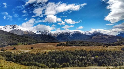 Scenic view of landscape and mountains against sky