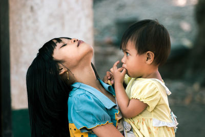 Side view of mother and daughter