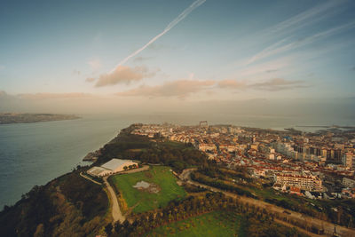 High angle view of townscape by sea against sky