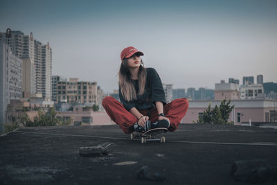 Portrait of young woman sitting on chair