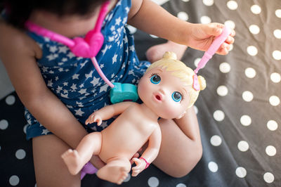 High angle view of girl holding toy