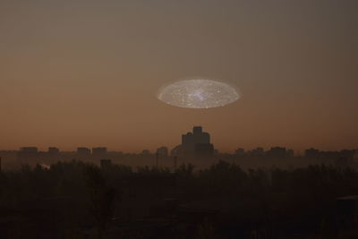 View of illuminated city at sunset