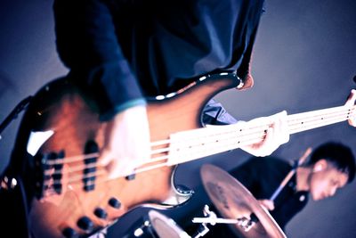 Close-up of man playing guitar