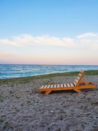 Scenic view of sea against sky, and a sunbed