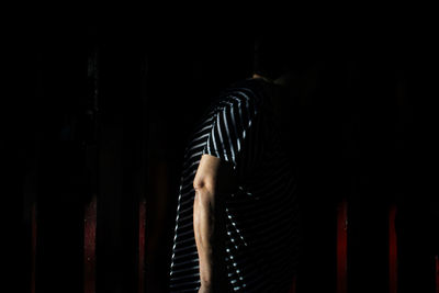 Man looking at camera in dark room