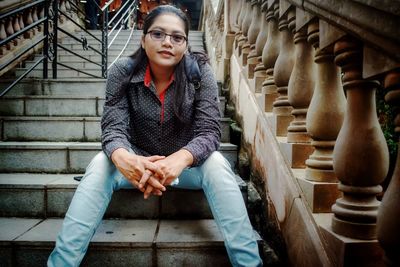 Portrait of woman sitting on staircase