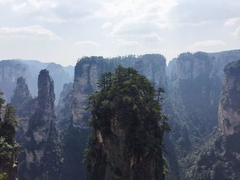 Panoramic view of trees and mountains against sky