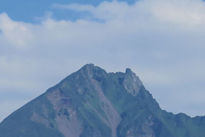 Low angle view of snowcapped mountains against sky