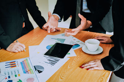 High angle view of people working on table