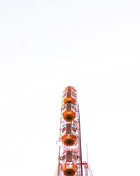 Low angle view of illuminated ferris wheel against clear sky