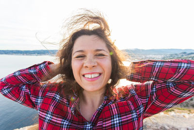 Portrait of smiling young woman at beach