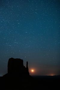 Low angle view of silhouette trees against sky at night