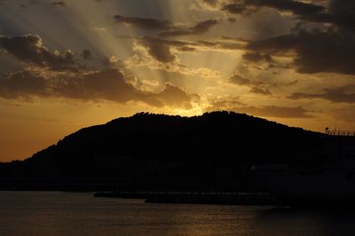 Scenic view of silhouette mountains against sky during sunset