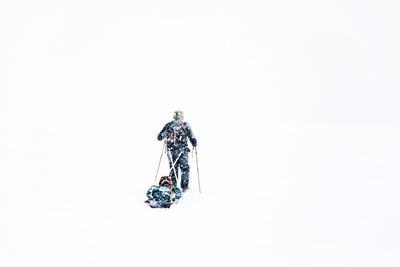 Rear view of man on snow against white background