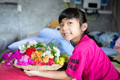 Portrait of smiling girl with flower petals