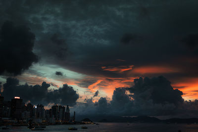 Scenic view of sea against dramatic sky during sunset