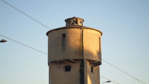 Low angle view of water tower against clear sky