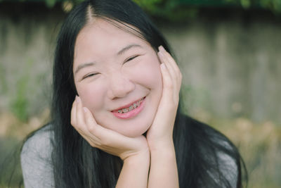 Close-up portrait of smiling young woman