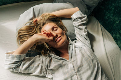 Young woman sleeping on bed at home