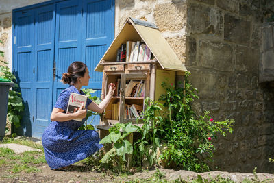 Woman takes the free books on the street library