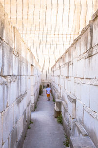 Rear view of people walking on footpath