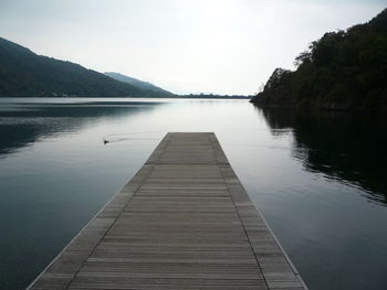 Pier over lake against sky