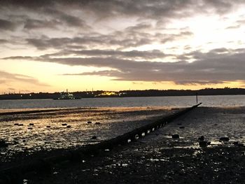 Scenic view of beach against sky during sunset