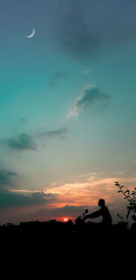 Silhouette people against sky during sunset