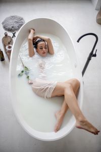 High angle view beautiful woman relaxing in bathtub