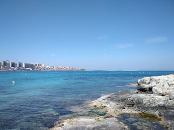 Scenic view of sea against blue sky