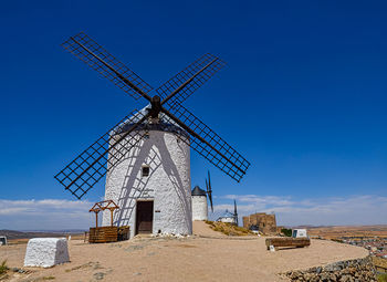 Windmills and castle in the background of the town of consuegra, spain