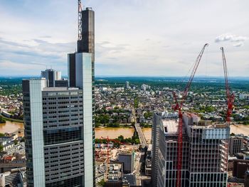 Skyscrapers against cloudy sky