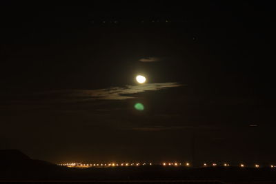 Scenic view of illuminated mountain against sky at night