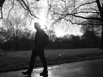 Silhouette of woman walking on road