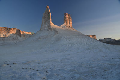 Rock formations on land against sky