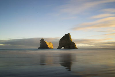 Scenic view of sea against sky at sunset