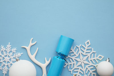 Directly above shot of christmas decorations on blue background