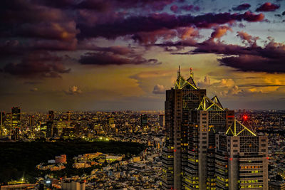 High angle view of illuminated cityscape against sky during sunset