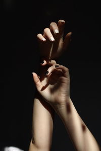 Hands holding over black background